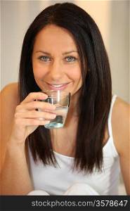 Brunette drinking glass of water