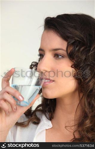 Brunette drinking water