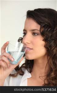 Brunette drinking water