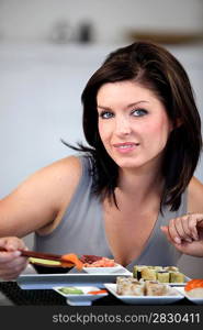 Brunette eating sushi