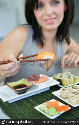 Brunette eating sushi