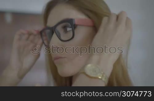 Brunette female woman taking off her glasses