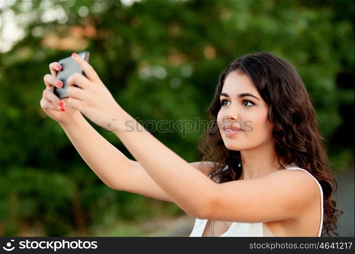 Brunette girl getting a photo with cellphone in park