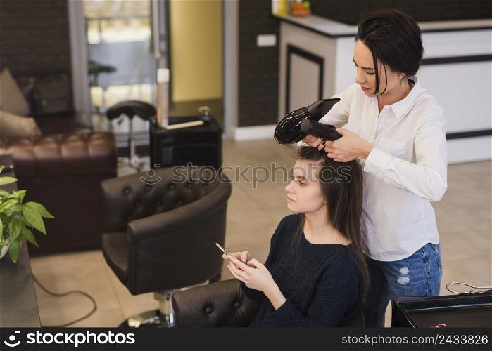 brunette girl getting her hair done