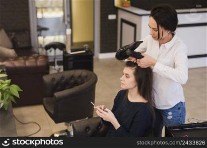 brunette girl getting her hair done