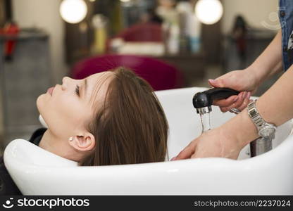 brunette girl getting her hair washed