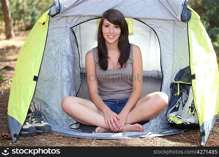 Brunette girl in front of tent