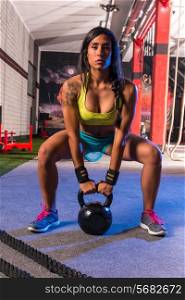 brunette girl kettlebell swing weightlifting workout exercise at gym