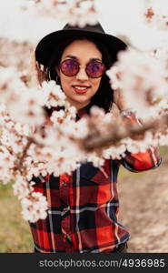 Brunette girl near a almond tree with many flowers