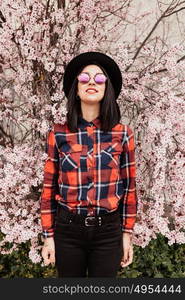 Brunette girl near a almond tree with many flowers