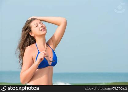 brunette girl sunbathing by the ocean