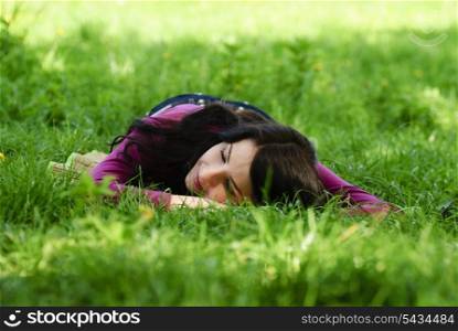 Brunette girl take pleasure and rest on the grass. Close up face