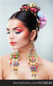 brunette girl with colourful earrings