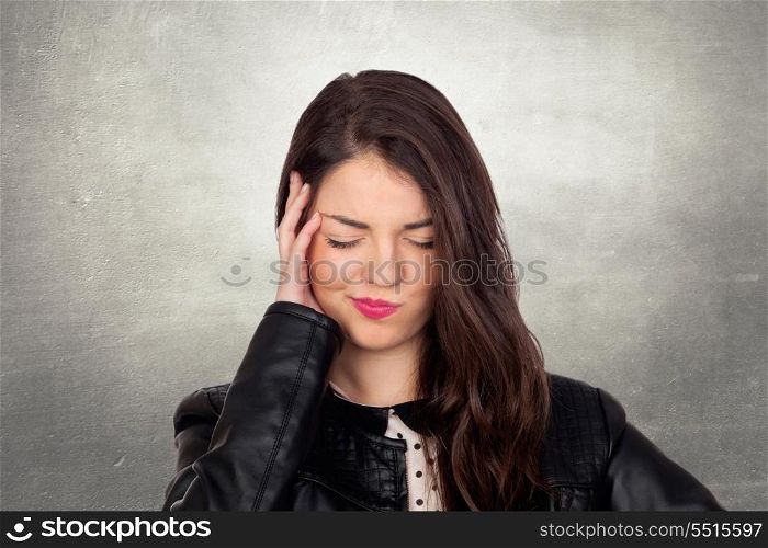 Brunette girl with headache on a irregular gray background