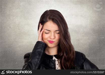Brunette girl with headache on a irregular gray background