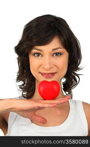 Brunette girl with heart in hand