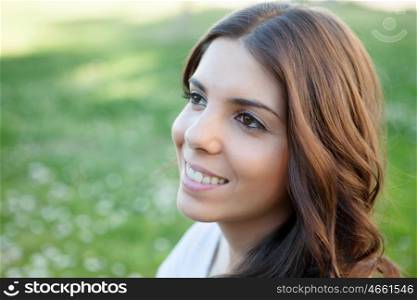Brunette girl with many daisies around and a beautiful smile