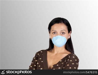 Brunette girl with mask isolated over grey