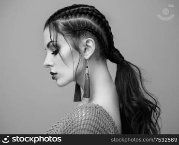 Brunette girl with perfect makeup. Beautiful model woman with curly hairstyle. Care and beauty hair products. Lady with braided hair. Model with jewelry. Black and white photo