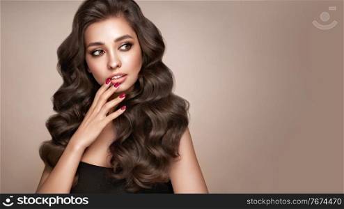 Brunette girl with perfect makeup. Smiling beautiful model woman with long curly hairstyle. Care and beauty hair products. Red nails manicure