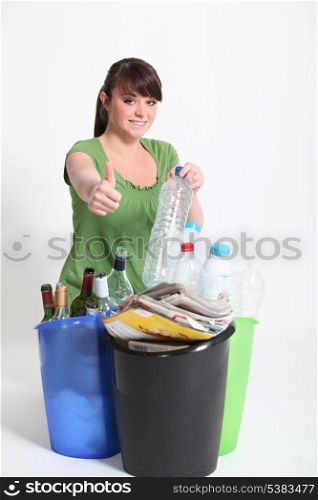 Brunette giving thumbs-up to recycling