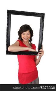Brunette holding empty picture frame