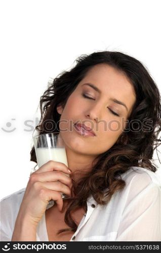 Brunette holding glass of milk