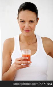 Brunette holding glass of tomato juice