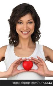Brunette holding heart-shaped object