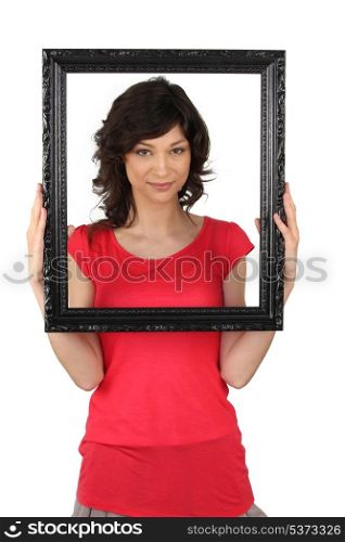 Brunette holding picture frame