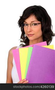 Brunette holding selection of colorful folders