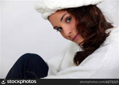 Brunette in a knitted cream jumper and hat