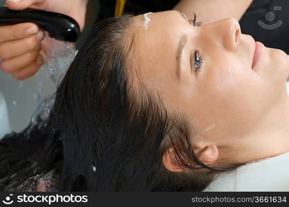 brunette in a salon getting washed her hair