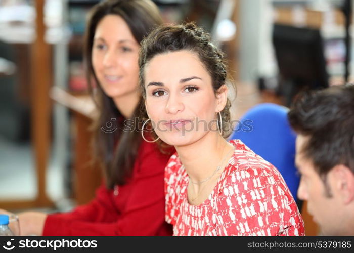 brunette in office with colleagues