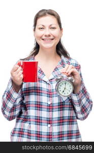 Brunette in pajamas with a mug of coffee and an alarm clock in t. Brunette in pajamas with a mug of coffee and an alarm clock in the morning isolated