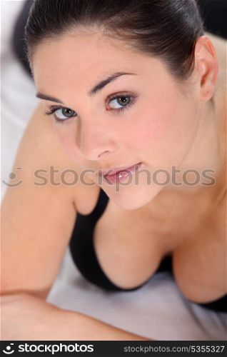 Brunette laying on bed in underwear