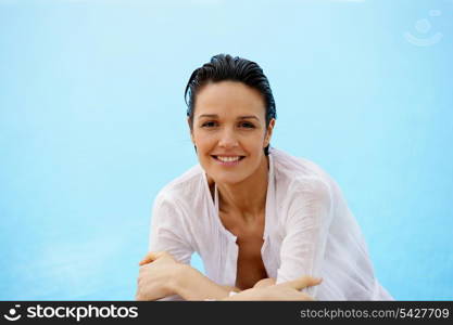 Brunette leaning at edge of pool