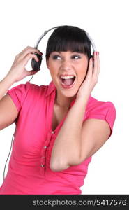 Brunette listening to loud music through headphones
