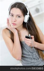 Brunette listening to music at home