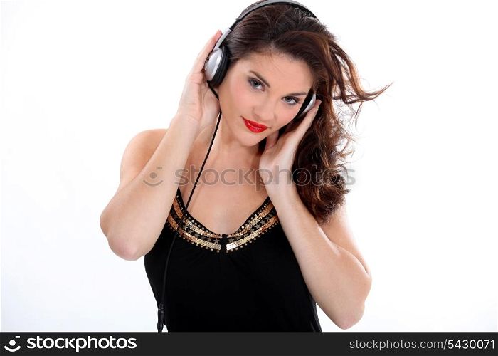 Brunette listening to music through headphones