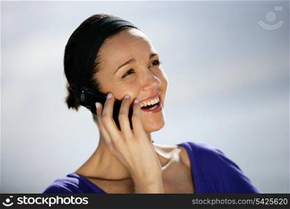 Brunette making a phone call outdoors
