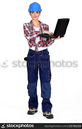 Brunette manual worker holding laptop