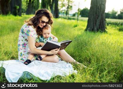 Brunette mother reading a fairy tale for her kid