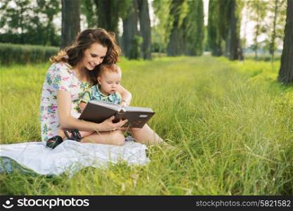 Brunette mother reading tales for her little child