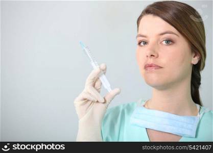 Brunette nurse holding syringe
