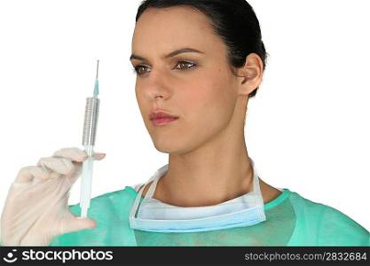 brunette nurse with hazel eyes holding syringe