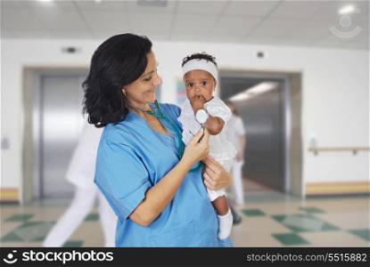 Brunette pediatrician at the hospital with a beautiful baby