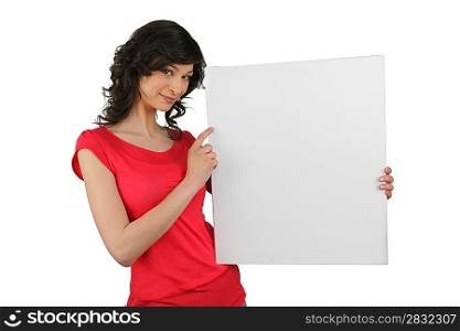 Brunette pointing to blank advertising board
