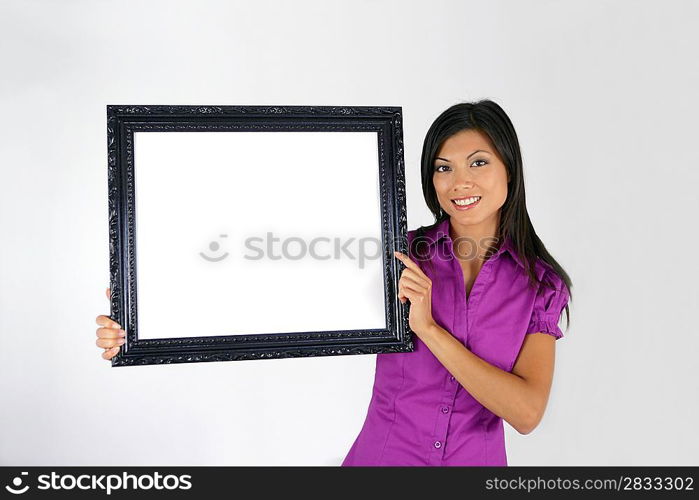 Brunette pointing to blank art frame