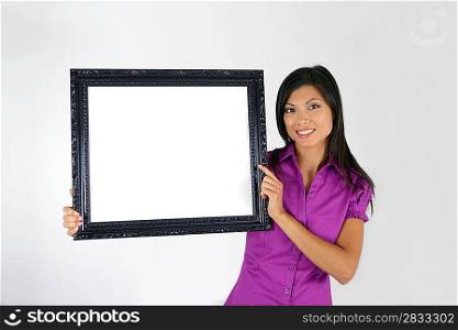 Brunette pointing to blank art frame